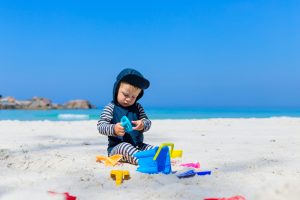 Small,Baby,Boy,Toddler,Wearing,Sun,Protection,Swimwear,Sitting,On